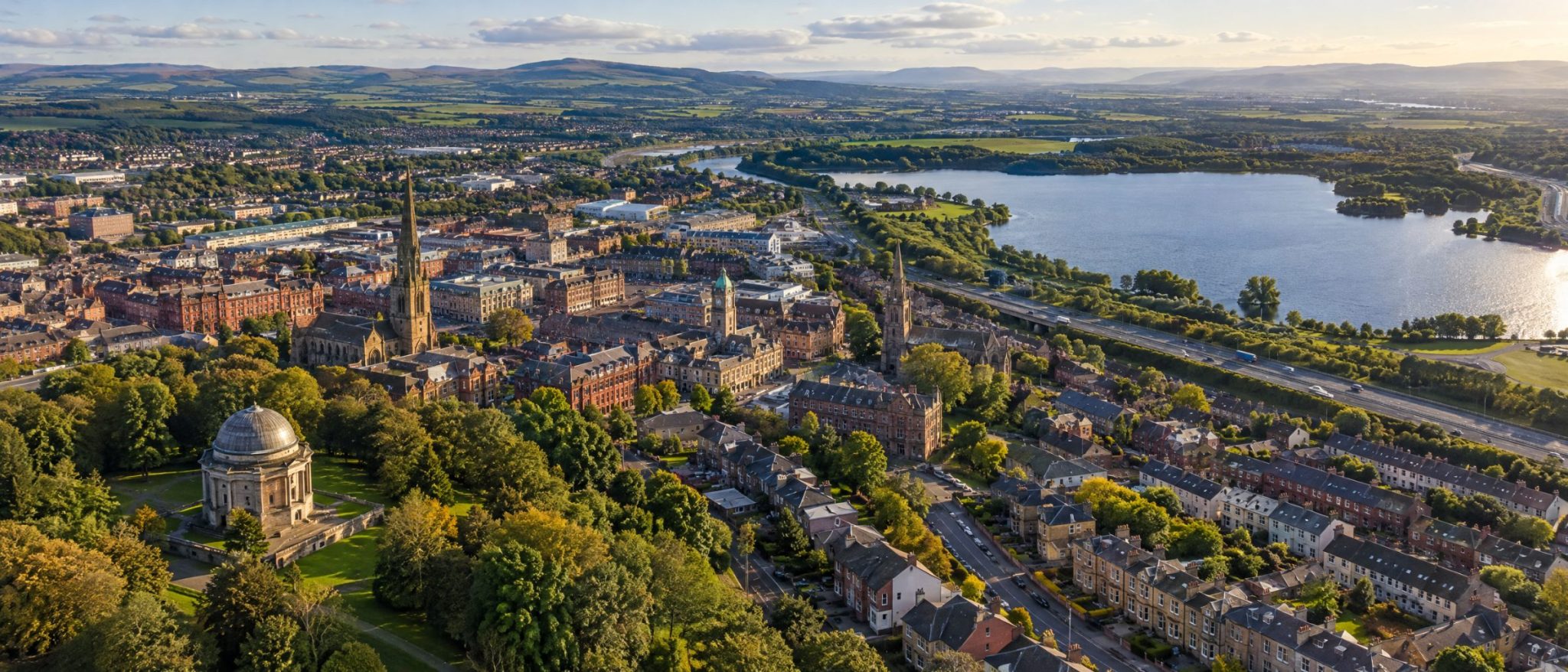 Aerial view of Hamilton with the Hamilton Mausoleum, the town centre and Strathclyde Loch