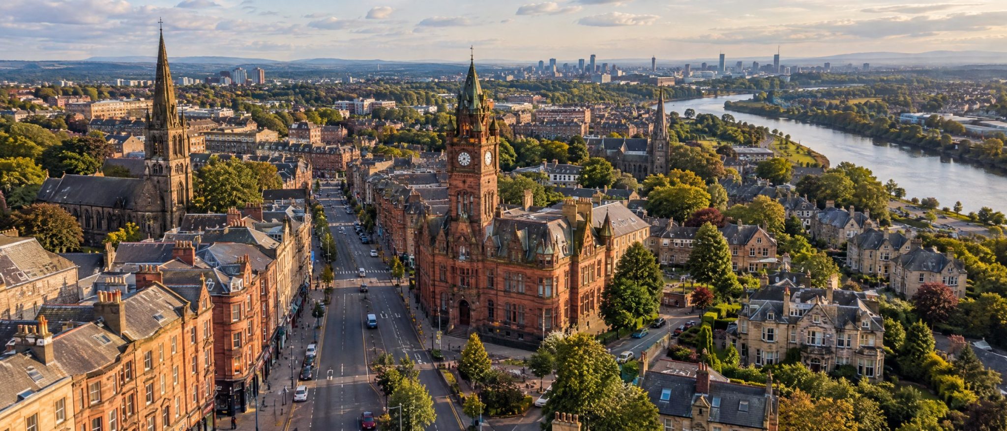Aerial view of Rutherglen Main Street and town hall, with the River Clyde and Glasgow beyond