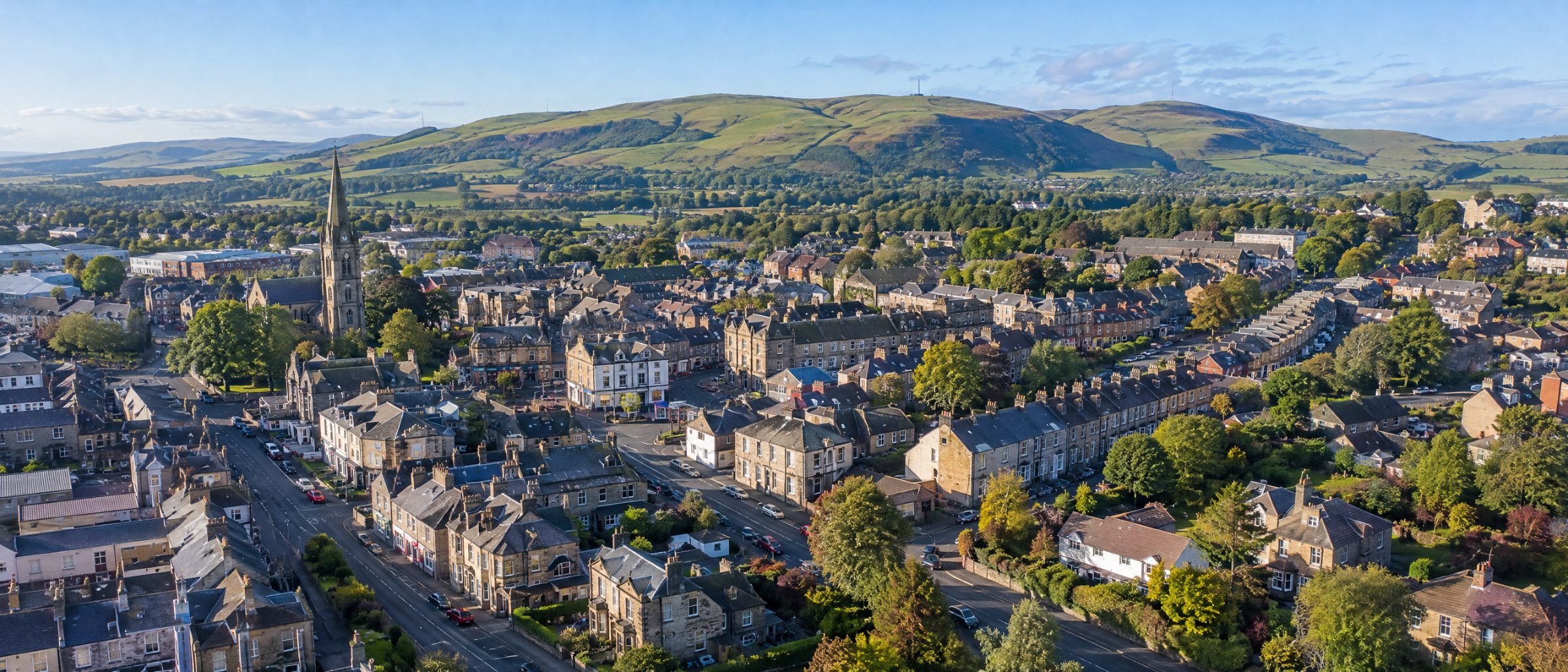 Aerial view of Bathgate town centre and homes, with the Bathgate Hills behind
