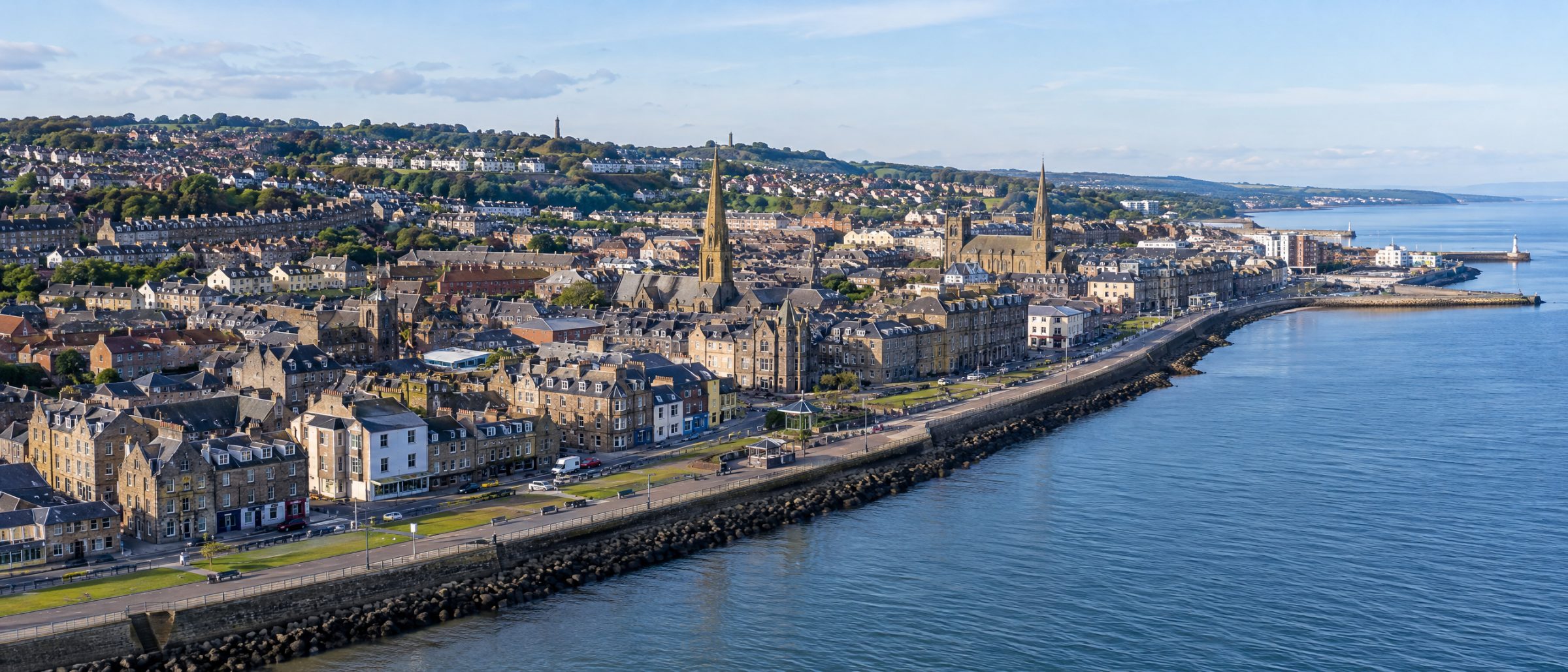 Aerial view of Kirkcaldy with the Esplanade sea wall, church spires and homes